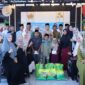 Ketua IKKKM Bengkalis, Rinto, berfoto bersama pengurus, anggota, serta anak yatim dan dhuafa usai penyerahan santunan dan bantuan sembako pada kegiatan buka puasa bersama di Cawan Coffee, Jalan Karimun, Bengkalis, Minggu (15/3/2026).
